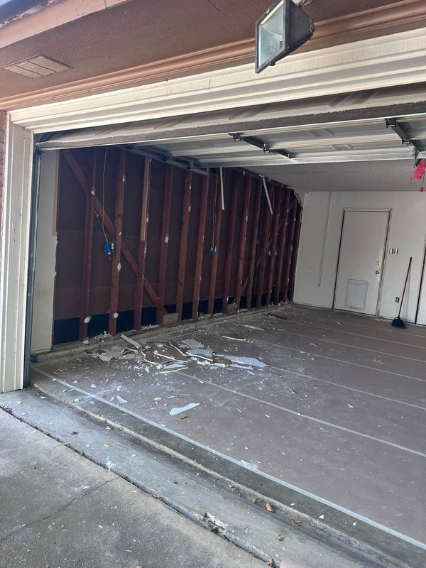 Garage taken back to the studs before a room conversion
