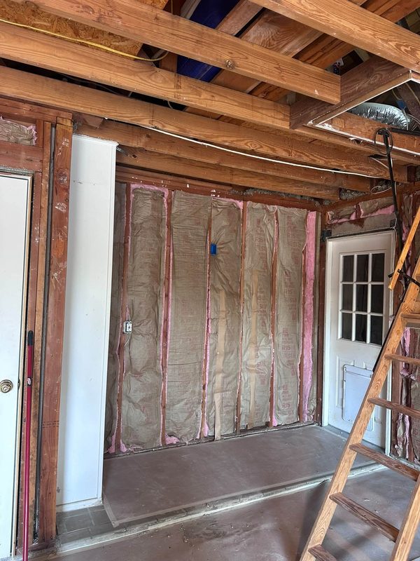 Old insulation and framing exposed before new walls go in