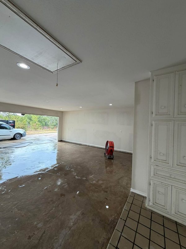 Garage conversion with new drywall and recessed lights, door opening still open