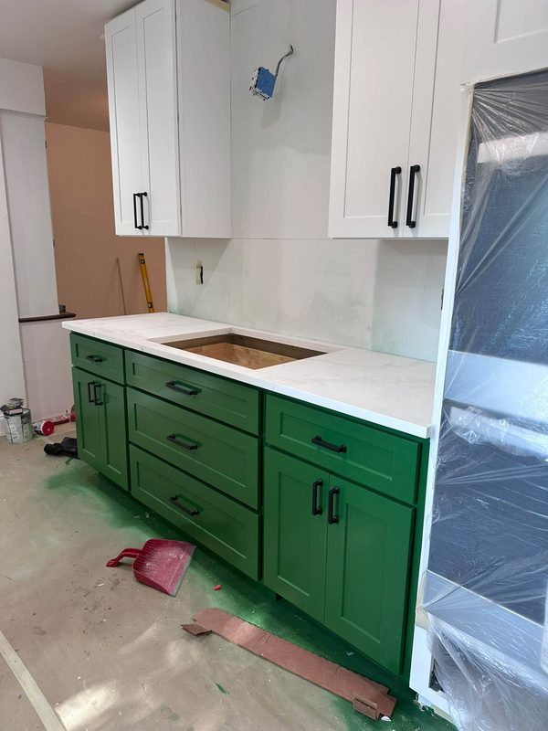 Green base cabinets set with the counters going in