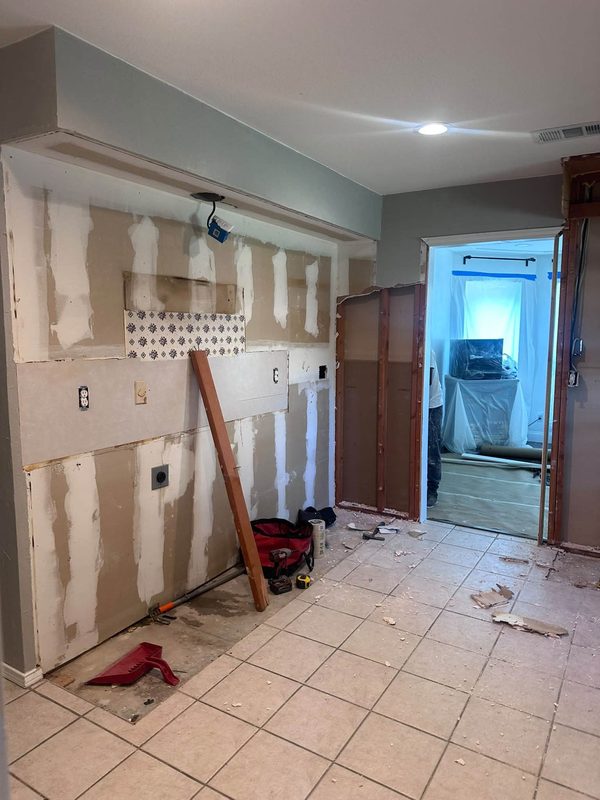 Kitchen walls opened up with drywall patched around the old cabinet lines