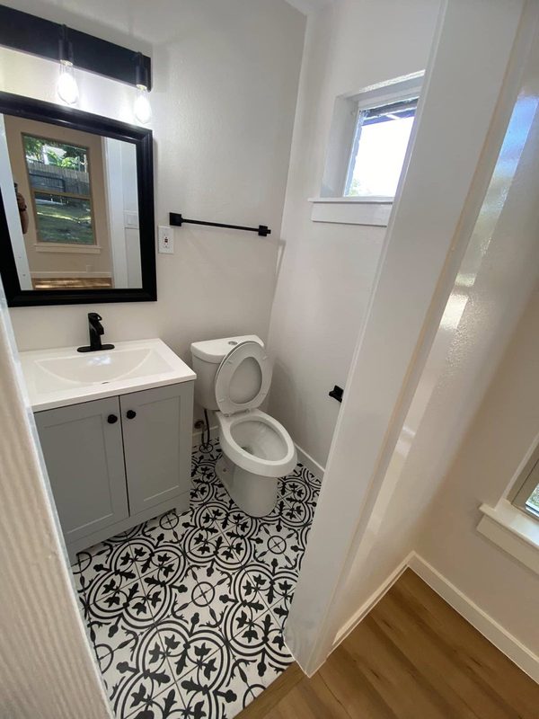 Half bath with patterned tile floor and new vanity