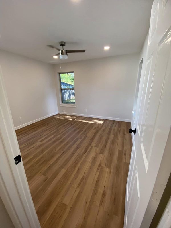 Bedroom with new wood look plank flooring down