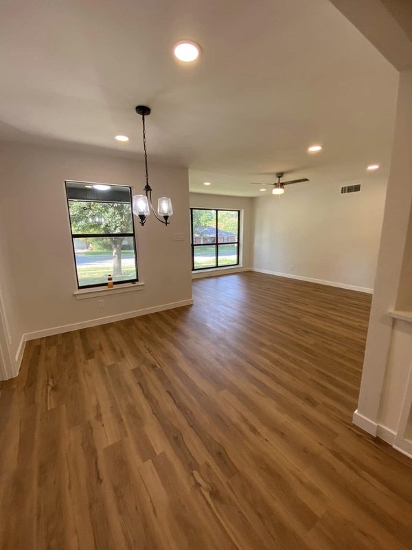 Open living and dining space with pendant lights