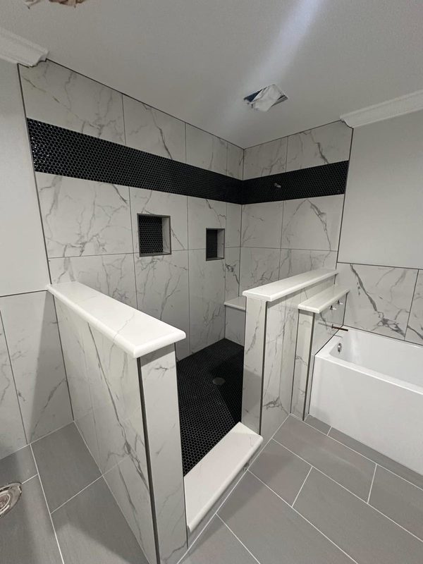 Marble look shower tile going in over framed knee walls