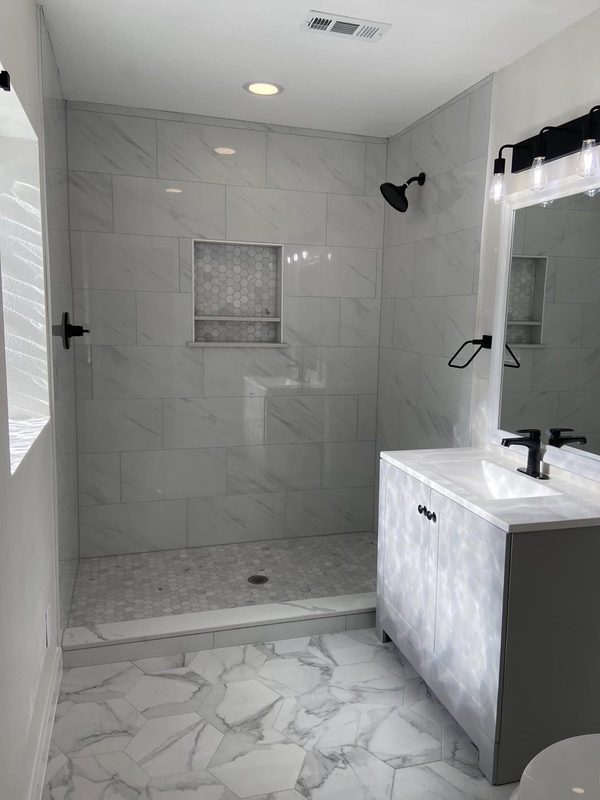 Walk in tile shower with niche and new vanity