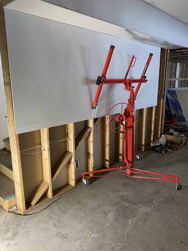 Setting a drywall panel with a lift