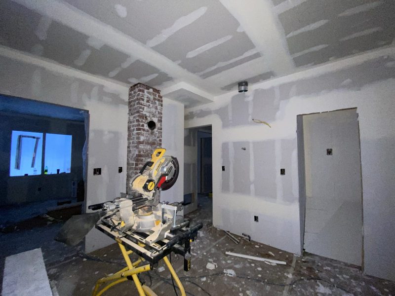 Drywall hung around the brick chimney
