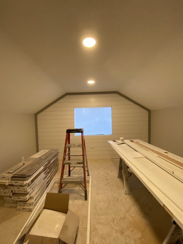 Attic bonus room finished with trim staged for install